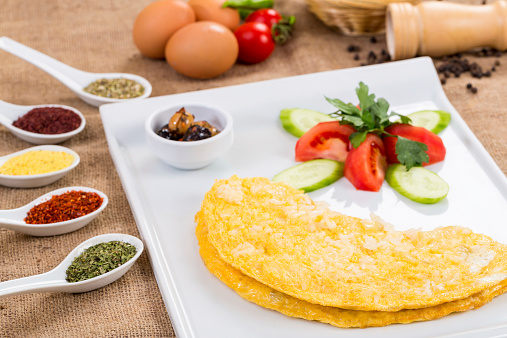 Omelet with white cheese and salad with green and black olive