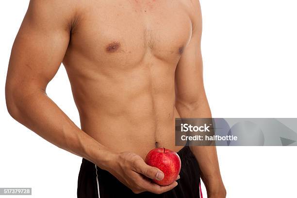 Muscular Asian Man Show Six Pack Abs With Red Apple Stock Photo - Download Image Now