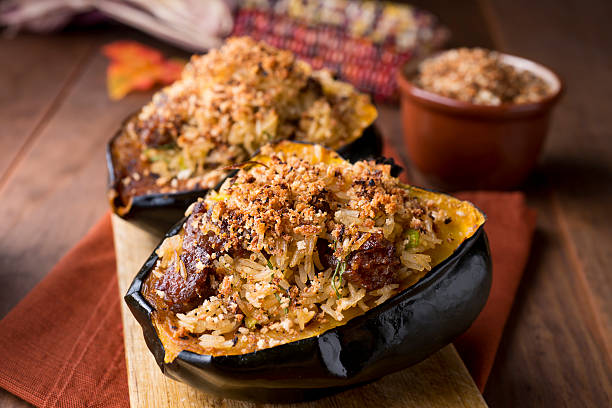 Acorn Squash Roasted Acorn Squash Stuffed With Rice and Sausage. acorn squash stock pictures, royalty-free photos & images