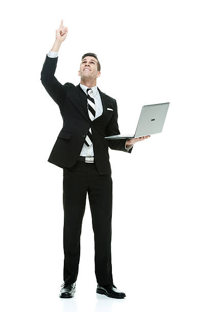 istock Smiling businessman holding laptop and pointing 517382174