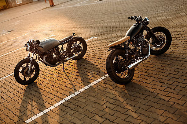 istock Two black and silver vintage custom motorcycles caferacers 517383284