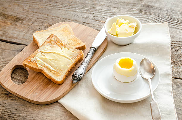 istock Boiled egg with crispy toasts on the wooden table 517396689
