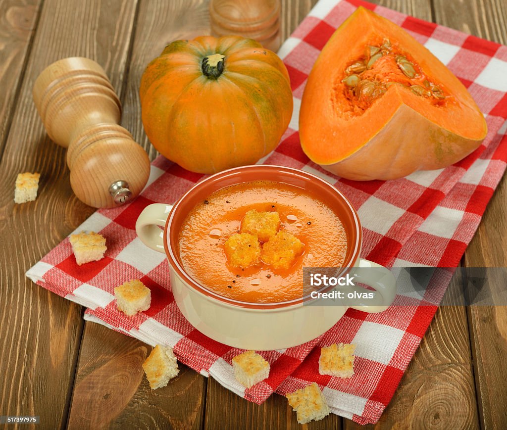 Pumpkin soup Pumpkin soup on brown background Backgrounds Stock Photo