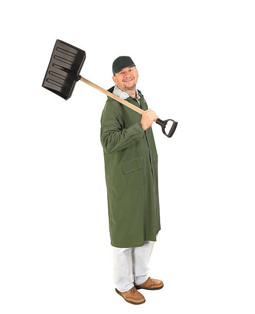 istock Man in long vest with shovel. 517399863