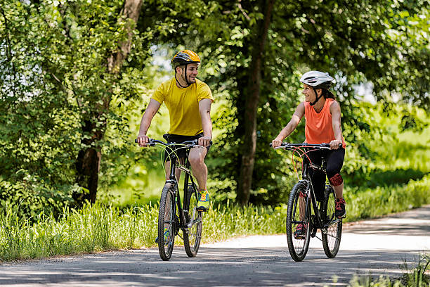 istock Young couple riding bicycles 517402397