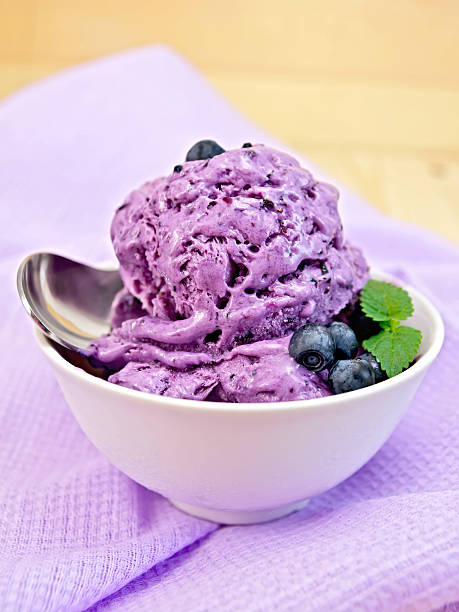istock Ice cream blueberry with spoon on napkin 517402643