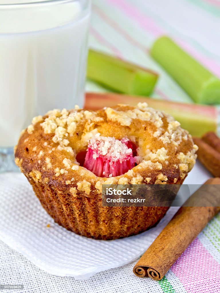 Cupcake with rhubarb and milk on napkin Cupcake with rhubarb, cinnamon on a paper napkin, rhubarb, milk in a glass on a background of a linen tablecloth Backgrounds Stock Photo