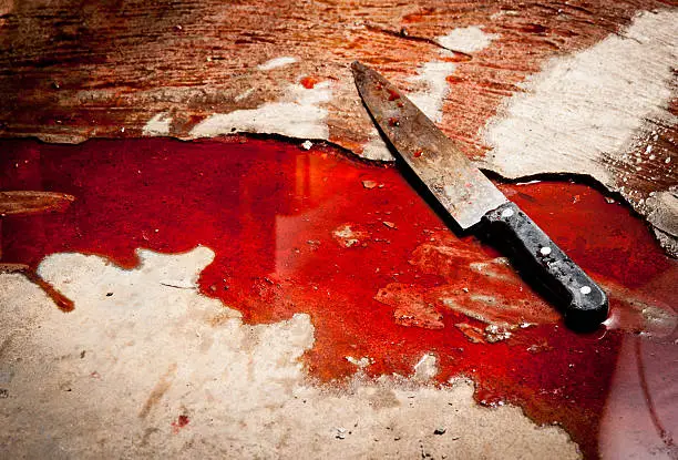Photo of Conceptual image of a sharp knife with blood on floor