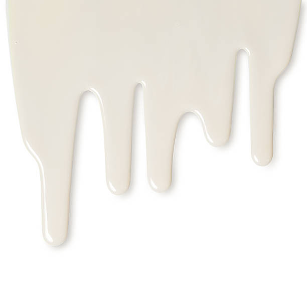 istock Dripping white milk, cream, paint yogurt on white background 517410310