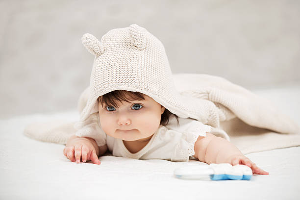 istock Baby girl lying on blanket indoors 517414358