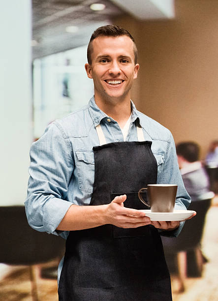 istock Male barista holding cup in restaurant 517414980