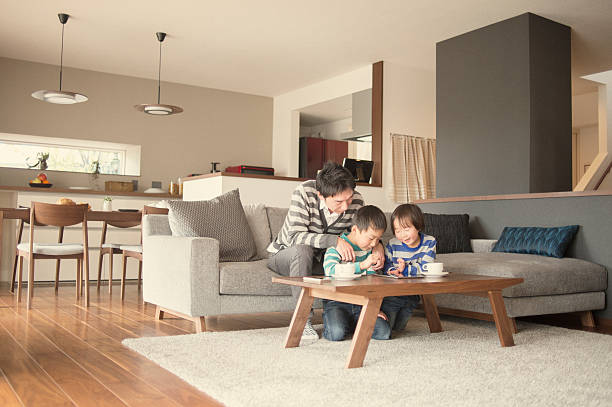 istock Father and two sons playing with a digital tablet together 517416146