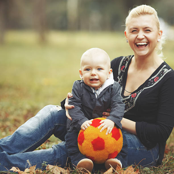 istock Young mother with lovely son in spring garden. 517417075