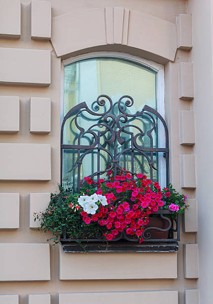 istock Window in a classic style and a box of flowers. Architecture 517417190