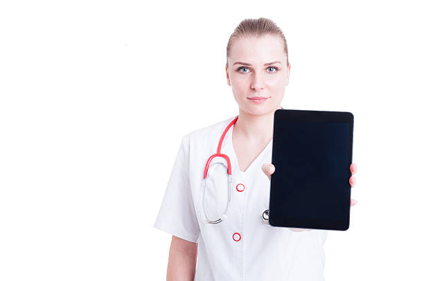 istock Confident medic or doctor woman showing blank screen display tab 517417952