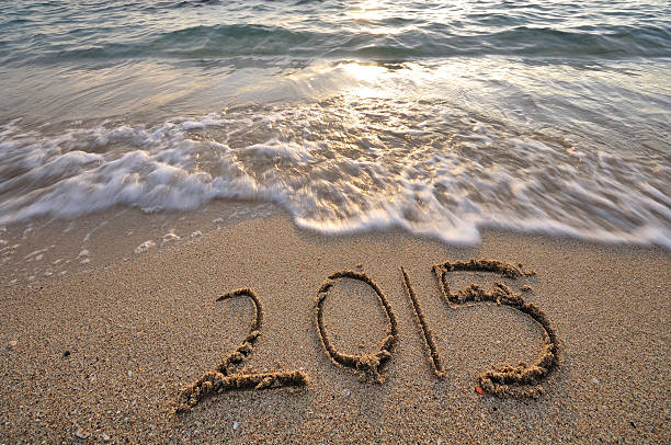 istock year 2015 handwritten on a beach sand 517418361