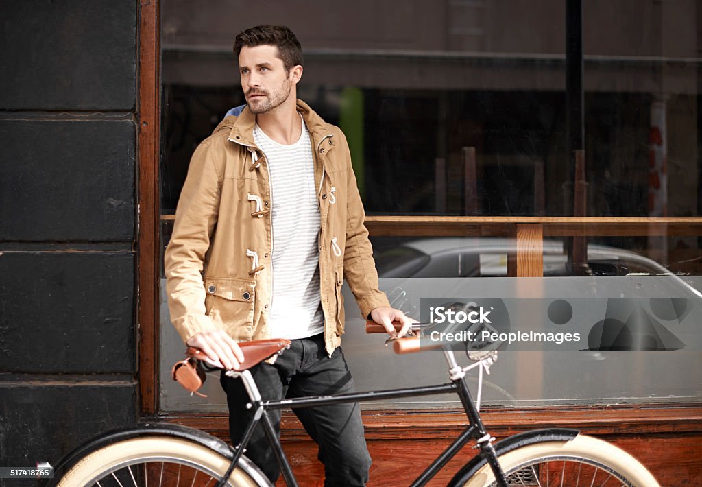 Just a man and his bike Cropped shot of a fashionable young man walking with his bicycle Bicycle Stock Photo