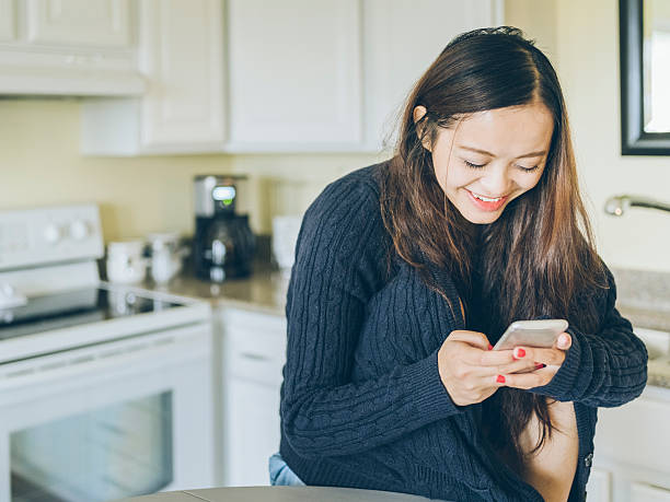 istock asian woman checking phone messages 517419258