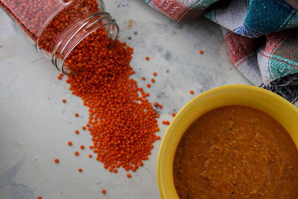 lentil red cream soup in yellow plat