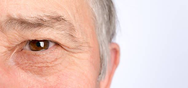 Close-up view on the eye of senior man. Horizontal photo stock photo