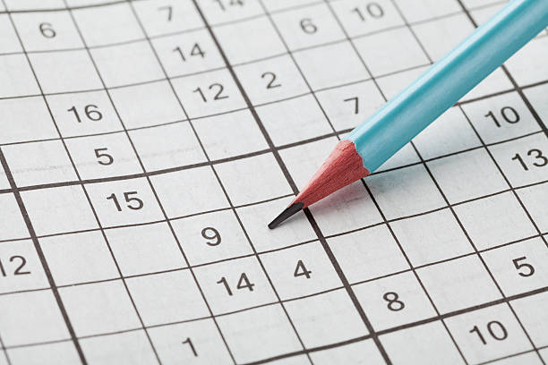 istock Crossword sudoku and blue pencil for entertainment 517420964