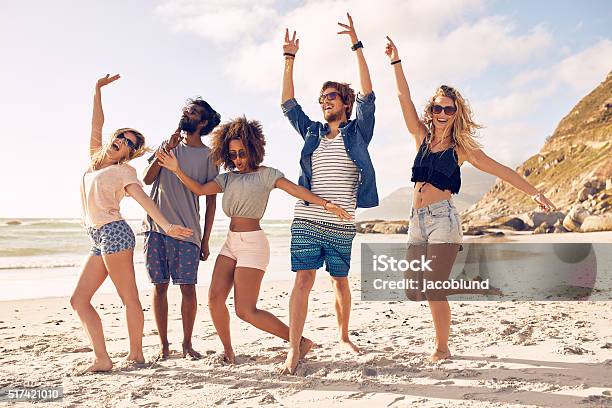 Group Of Friends Having Fun At Beach Stock Photo - Download Image Now - Beach, Friendship, Dancing