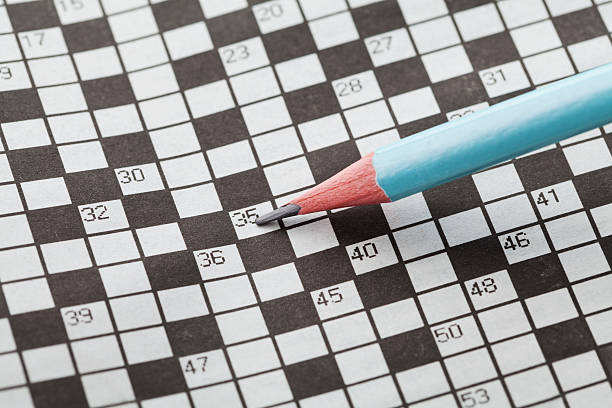 istock Crossword puzzle or rebus and blue pencil 517421188