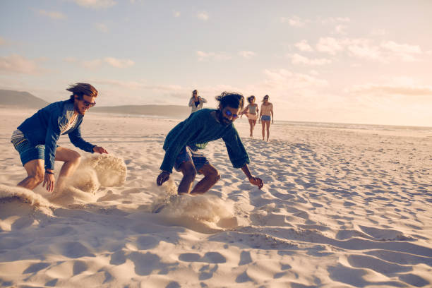 istock Young men running race on the beach 517421234