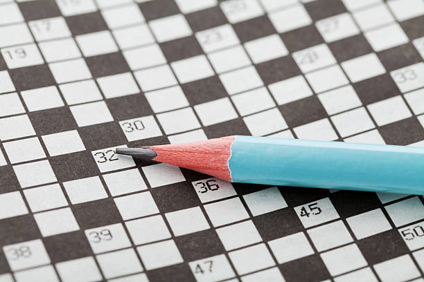 istock Closeup crossword puzzle and blue pencil 517421422