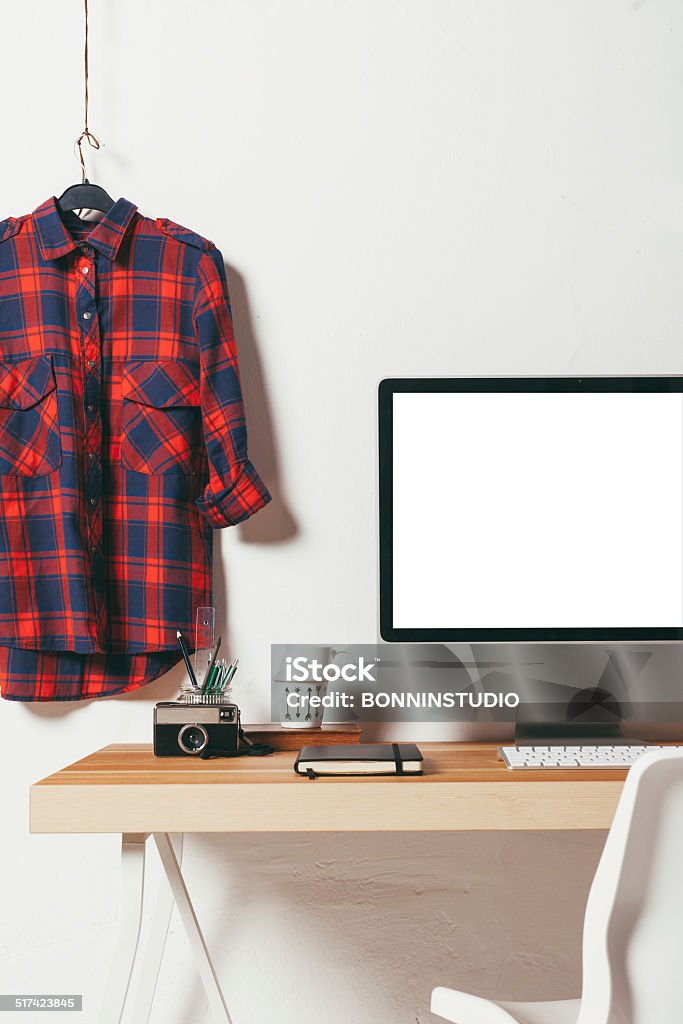 Closeup of minimal office on white background. Industrial workspace with computer. Button Down Shirt Stock Photo