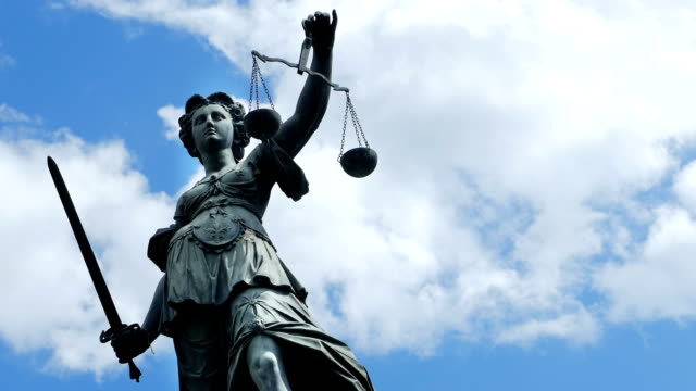 Lady Justice Against Cloudy Sky (4K/UHD to HD)