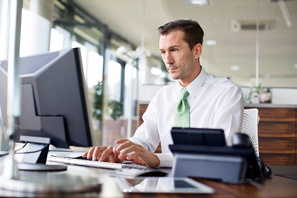istock Determined businessman working at his desk 517441851
