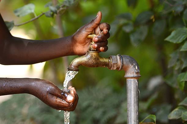 istock Drinking Water from a Tap - Water Scarsity Symbol 517444877