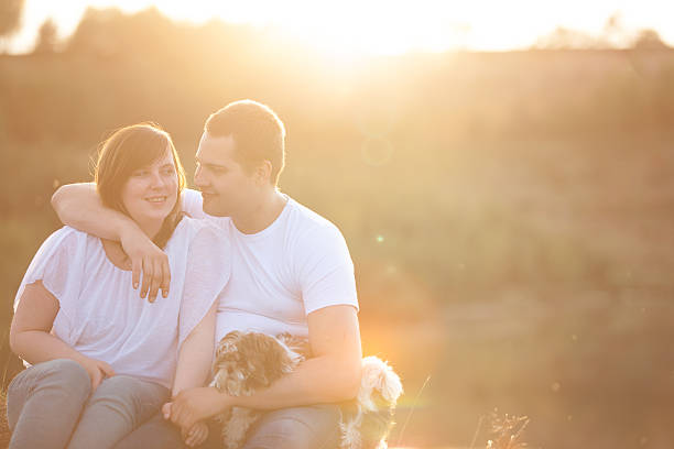 istock Young couple and puppy in sunlight 517445427
