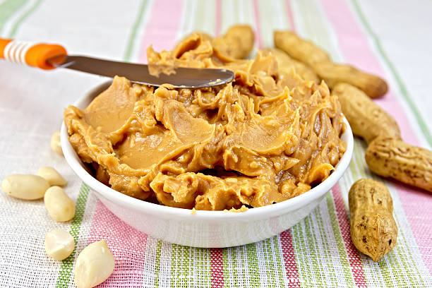 istock Butter peanut with a knife on tablecloth 517446373
