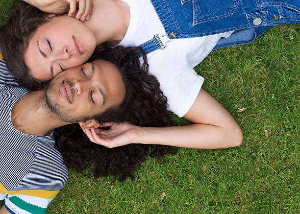 istock Young Couple Lying on Grass Together 517447679