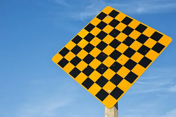 Black and yellow checkered traffic warning sign