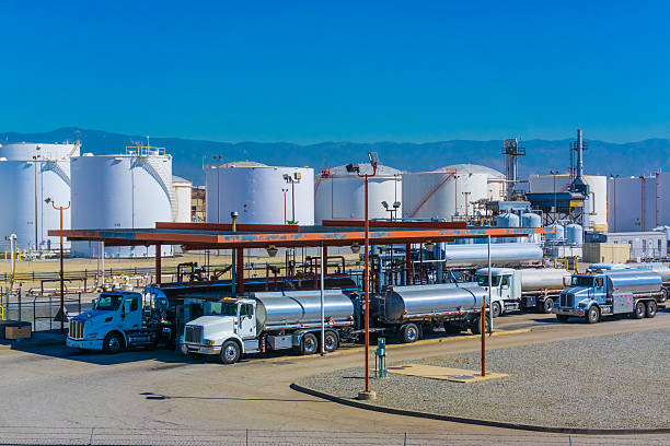 Fuel tanker trucks Fuel tanker trucks at refinery fueling station, CA storage tank photos stock pictures, royalty-free photos & images
