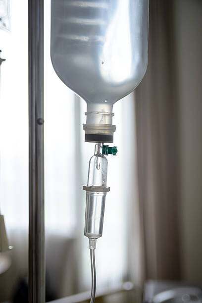 istock Close up IV saline solution drip for patient in hospital 517449437
