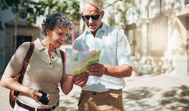 istock Senior couple reading a tourist map 517457992