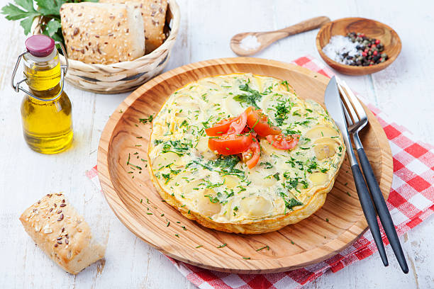 Omelet with potato from spain called tortilla de patatas Omelet with potato from spain called tortilla de patatas on a wooden background tortilla de patatas stock pictures, royalty-free photos & images