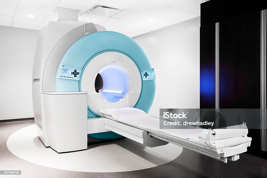 MRI – Magnetic Resonance Imaging machine Image showing a new open bore MRI scanner in clean medical centre. Horizontal with bed extended. MRI Scanner Stock Photo