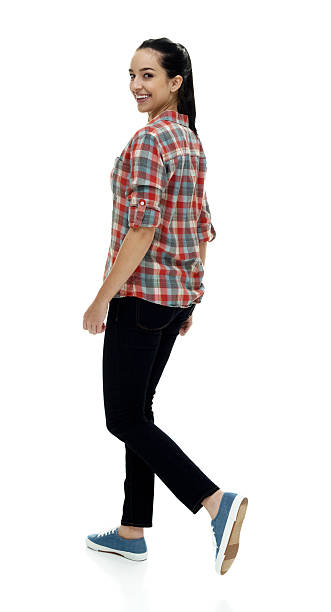 istock Smiling female walking and looking at camera 517460740