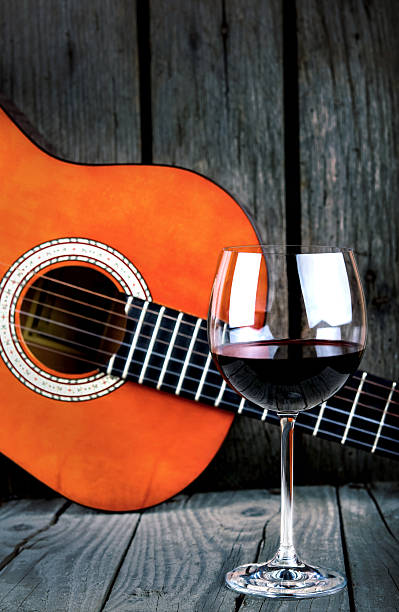 Wine and Guitar on a wooden table vintage retro photo stock photo