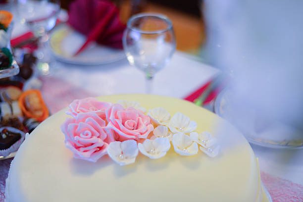 istock white wedding cake with pink  roses 517467898