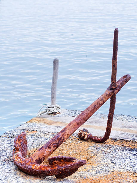 istock rusty anchor on the dock near the sea 517468386