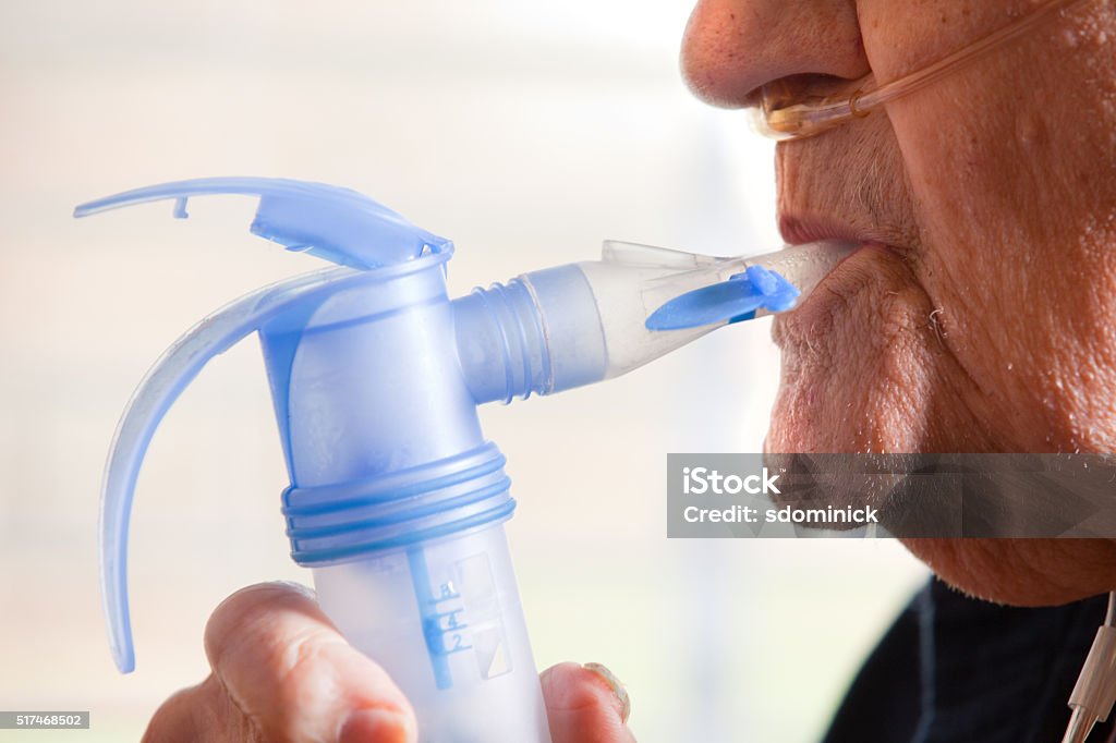 Close Up Of Elderly Man Using Nebulizer A close up of a 91 year old man using a nebulizer. Chronic Obstructive Pulmonary Disease Stock Photo