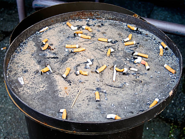 Cigarette butts in a outdoor ashtray stock photo