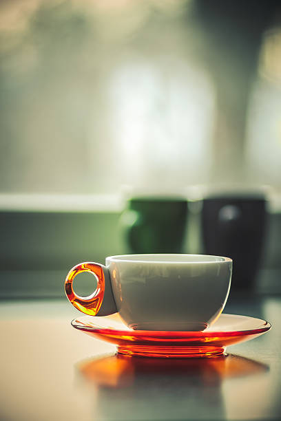 istock White coffee tea cup in front of window matte 517470084
