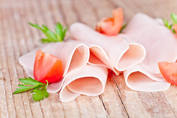 slices of ham with parsley and tomato stock photo